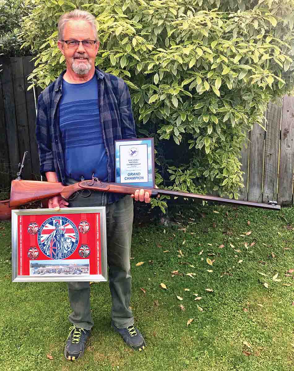 New Zealand rifleman Laurie Kerr with his .40 long-range rifle and the USA Long Range Championship and International Long Range Championship awards.